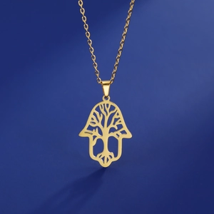 Detailed view of golden Hamsa Hand pendant with Tree of Life cutout on a blue background