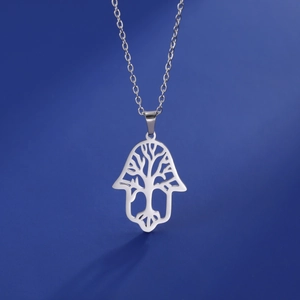 Detail of silver stainless steel Hamsa hand pendant with cutout Tree of Life design