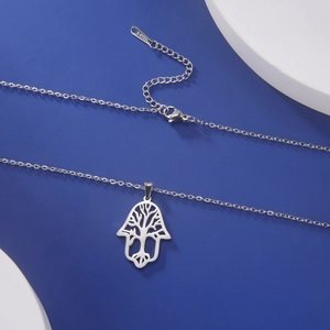 Detail of silver stainless steel Hamsa Hand pendant with hollow Tree of Life design