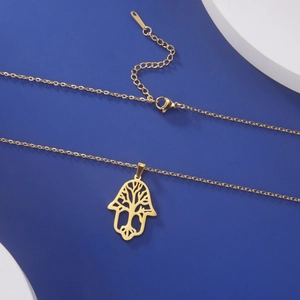Detailed close-up of gold stainless steel Tree of Life pendant with Hamsa outline and clasp
