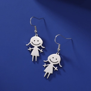 Detail of silver stainless steel cartoon girl earrings on dark blue background