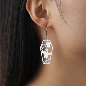 Detail of Halloween ghost earrings featuring a white coffin design with spider web patterns