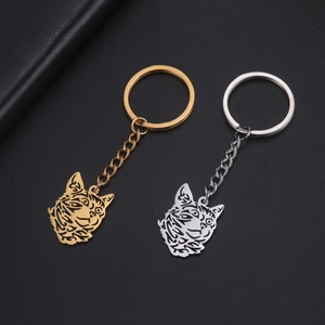 Hollow cat head metal keychains in gold and silver finish with tribal style art