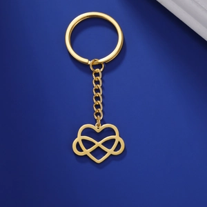Detailed view of golden infinity heart keychain with chain on deep blue background