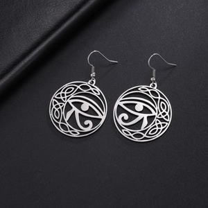 Detailed view of stainless steel Eye of Horus earrings with Celtic knot cutouts
