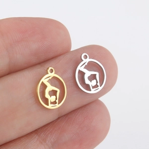 Stainless steel yoga silhouette pendants in gold and silver finish on fingertip