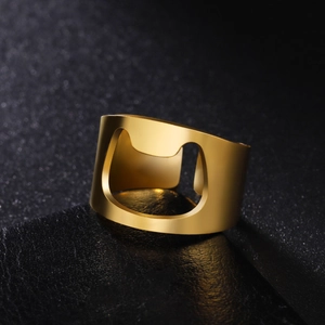 Macro view of gold stainless steel bottle opener ring with brushed metallic texture