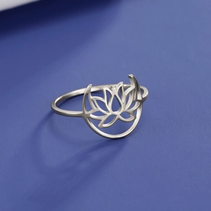 Macro view of silver stainless steel ring featuring lotus flower and crescent moon design