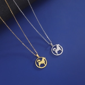Dog silhouette pendant necklaces in gold and silver finish on a navy textured background