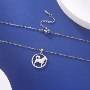 Close-up of a silver stainless steel necklace with a hollow Shiba Inu dog pendant charm