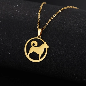 Detailed close-up of a hollow dog silhouette pendant in gold-plated stainless steel