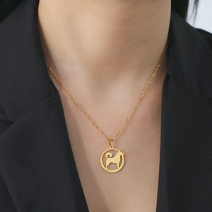 Elegant gold stainless steel necklace featuring a cutout dog silhouette pendant on a model