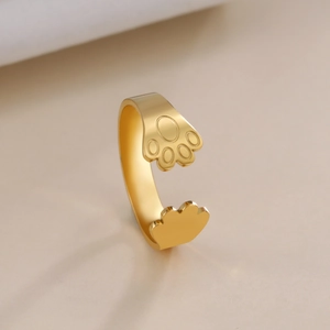 Detailed view of golden adjustable ring featuring cute animal paw print design on silk