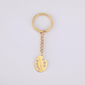 Polished golden stainless steel keychain with creative artist palette pendant detail
