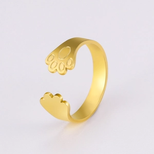 Detail of adjustable gold cat paw ring showcasing intricate animal motif and texture
