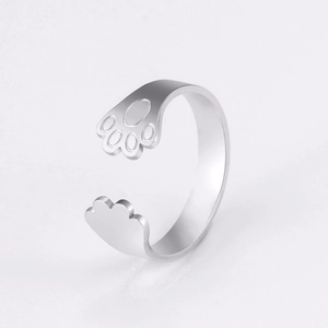 Macro detail of silver dog paw adjustable open ring showing the cute animal design