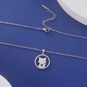 Macro detail of silver cat silhouette pendant with hollow heart on minimalist jewelry