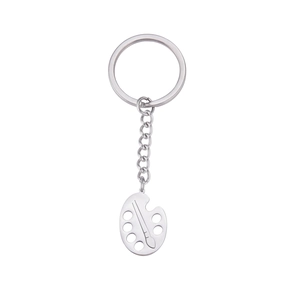 Creative artist palette keychain in stainless steel with paintbrush charm on white background