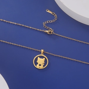 Detail of gold cat silhouette pendant with hollow heart on polished steel chain