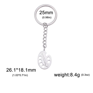Artistic stainless steel palette and brush keychain with a polished silver metallic finish