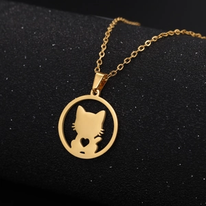 Minimalist gold cat silhouette pendant necklace with heart detail on black background