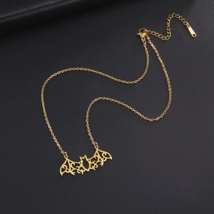 Close-up of golden bat pendant necklace with hollow patterns and lobster clasp closure