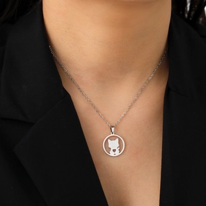 Close-up of a silver cat pendant necklace featuring a heart cutout on a O-chain link