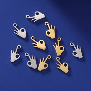 DIY jewelry charms in gold and silver colors featuring creative OK gesture hand shapes