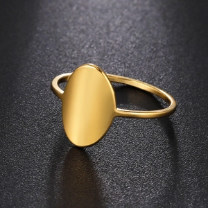 Detailed view of polished golden stainless steel oval signet ring with smooth finish