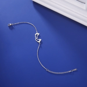 Detail view of silver stainless steel footprint charms on a delicate adjustable chain link