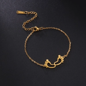Detail of gold stainless steel bracelet with cutout baby footprint charms and lobster clasp