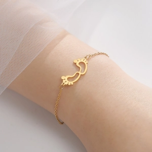 Elegant gold baby footprint charm bracelet for women on a delicate stainless steel chain