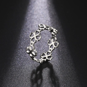 Macro shot of silver hollow clover pattern ring with high-polished metallic finish