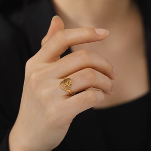 Polished gold stainless steel ring featuring a cutout heart and cat paw print design