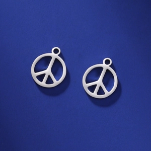 Polished stainless steel peace symbol pendants for DIY jewelry making on blue background