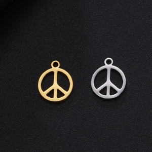 Macro shot of silver and gold peace sign pendants made of polished stainless steel