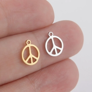 DIY stainless steel hollow peace sign pendants in gold and silver held between fingertips