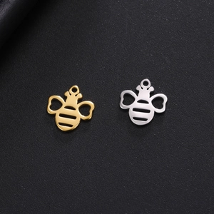 Macro shot of gold and silver bee-shaped stainless steel charms for DIY jewelry making