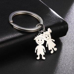 Polished stainless steel keychain with minimalist cartoon boy and girl pendants on leather