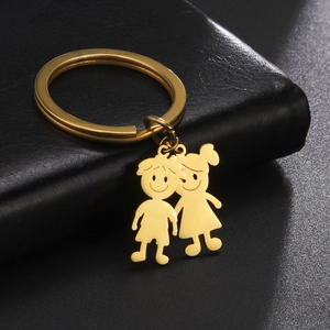 Golden stainless steel keychain featuring minimalist cartoon boy and girl pendant charms