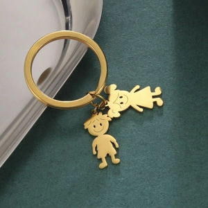 Detail of high-polish champagne gold stainless steel cartoon boy and girl keychains