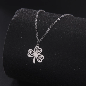 Silver Celtic Knot Shamrock Pendant Necklace on minimalist black cylindrical stand