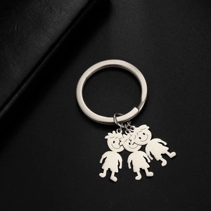 Close-up of polished stainless steel family charms with boys and girls on black leather