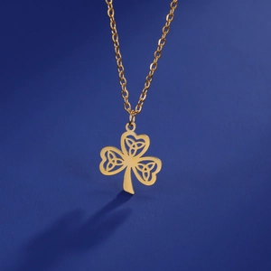 Detailed view of golden Celtic knot clover pendant on a stainless steel chain