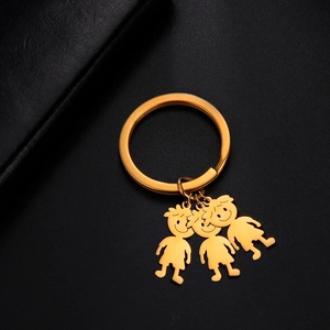 Golden stainless steel keychain featuring cute cartoon family charms on a black background