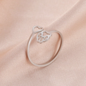 Detail of adjustable silver stainless steel ring with hollow heart and paw print shapes