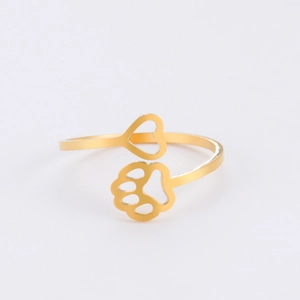 Close-up of golden adjustable stainless steel ring with heart and paw print design