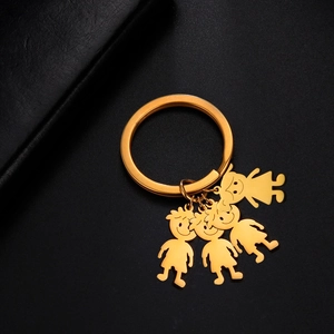 Detail of gold stainless steel keychain with four cute cartoon family charms on black leather