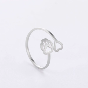 Close-up of silver stainless steel adjustable ring with hollow heart and paw print