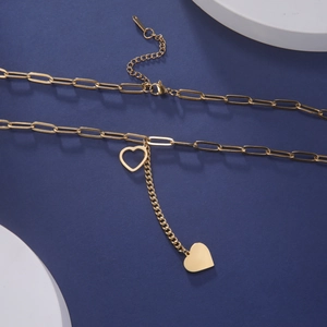 Close-up of 18k gold plated paperclip chain with hollow and solid heart charms